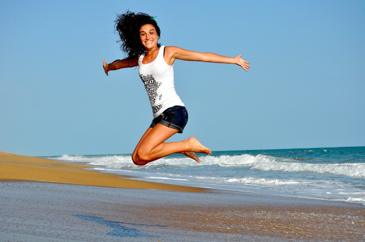 a person jumping on a beach